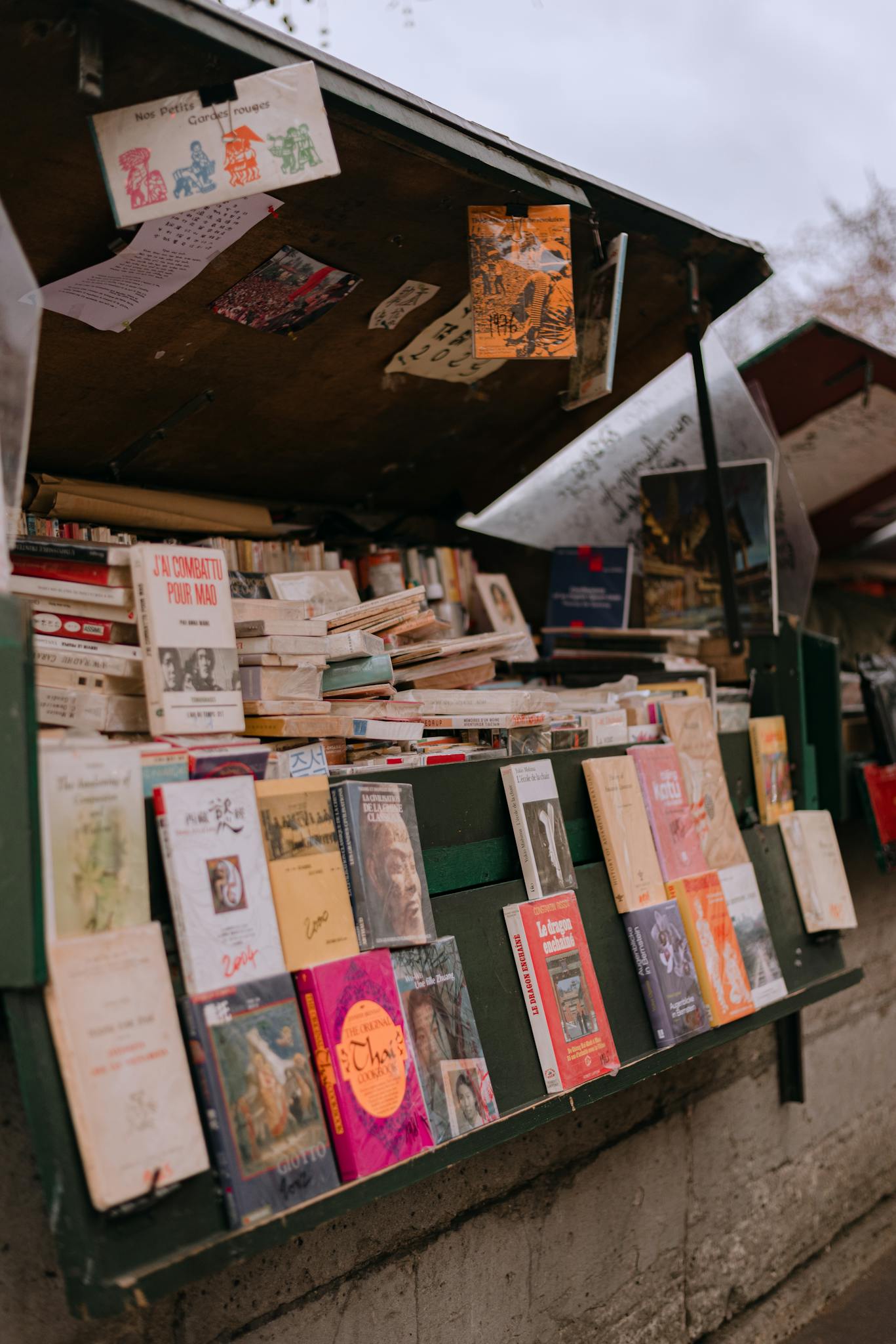 Paris book stall lined with vintage and new collections. Iconic Seine River view.